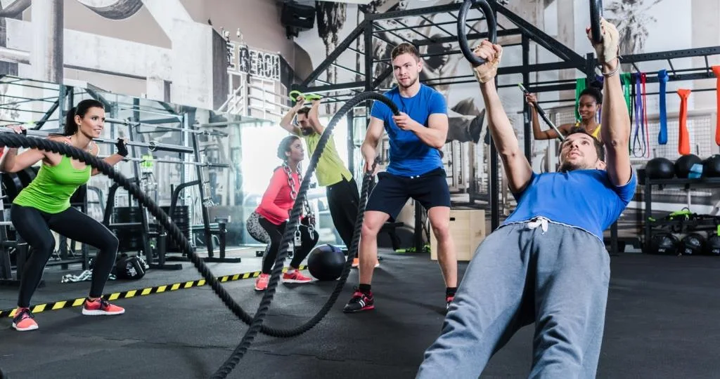 Men and women at functional fitness training in gym